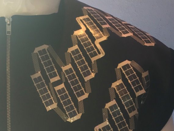 A solar shirt which can charge a smart phone.