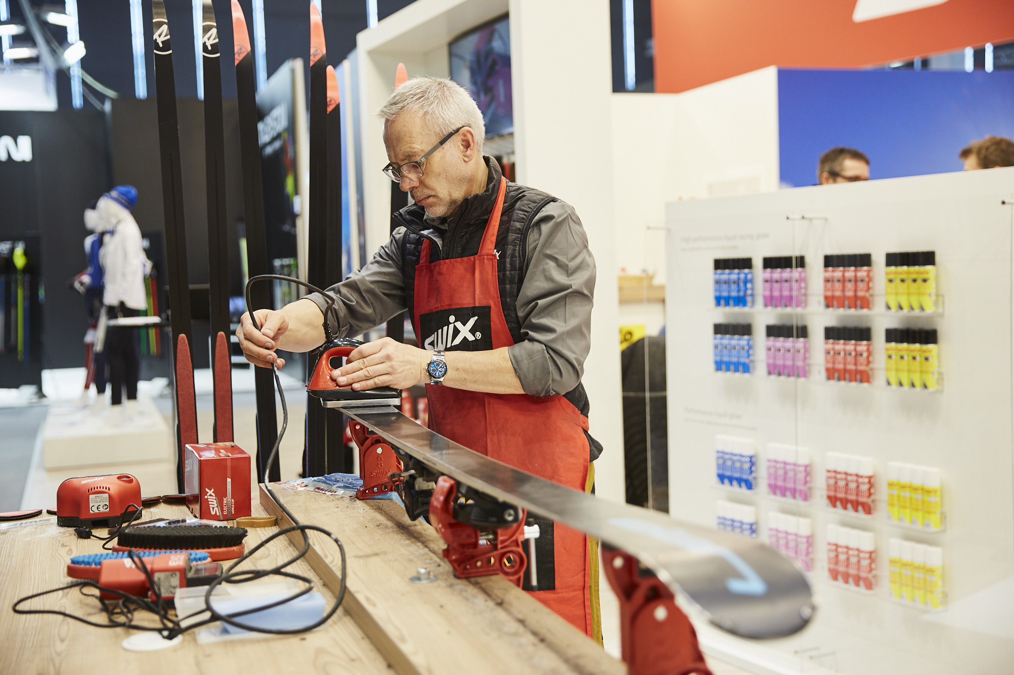 Exhibitor waxing skis of ISPO Munich Exhibitor waxing skis of ISPO Munich