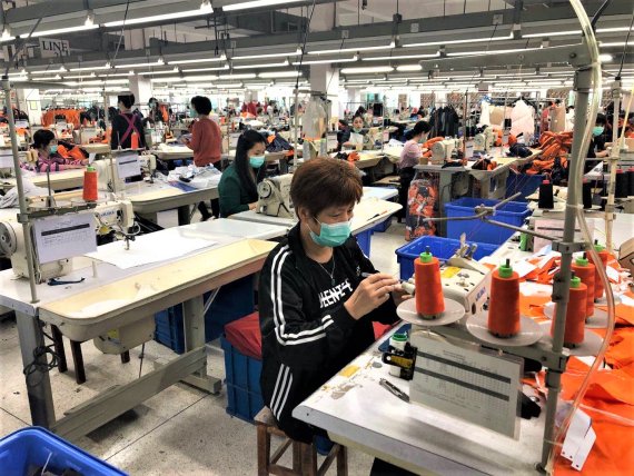 Die Produktion läuft in vielen Ländern wieder an - unter Einhaltung von Schutzmaßnahmen, wie hier in China beim Sporthersteller KTC.