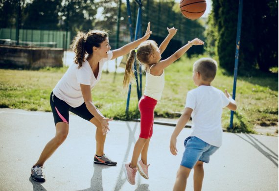 Mother plays basketball with her two children