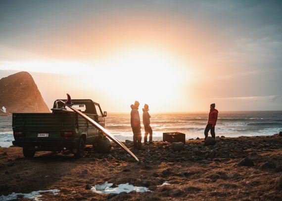 Outdoor Enthusiasten beobachten Sonnenuntergang am Meer