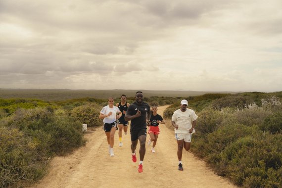 A group of runners jog through the countryside.