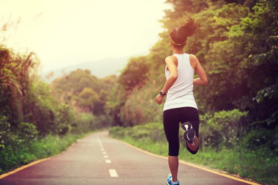 A woman jogs along a street.