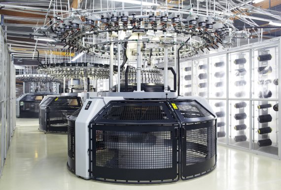 mb-170523-loeffler-strickmaschinen-2012 There are 24 such circular knitting machine in the Löffler knitting factory. Each day around 10,000 meters squared of material are knitted. That is equal to two football pitches.