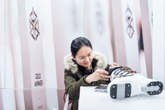 Woman looking at a ski boot Woman looking at a ski boot
