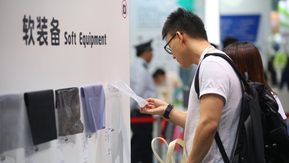 Textrends at ISPO Shanghai Man touching fabrics at ISPO Shanghai