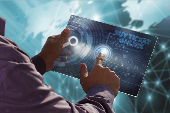Ticket ganz einfach online bestellen. Mann tippt auf Tablet, um Online-Ticket zu bestellen.