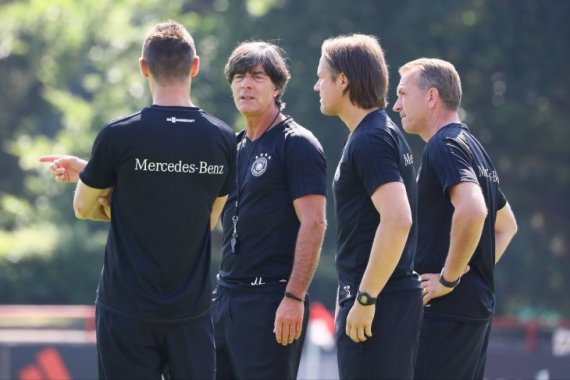 German national coach Joachim Löw (2nd from left) talking to parts of his coaching staff