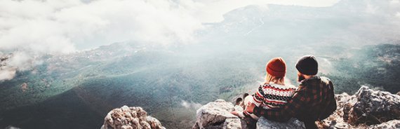 Couple sitting on a mountain