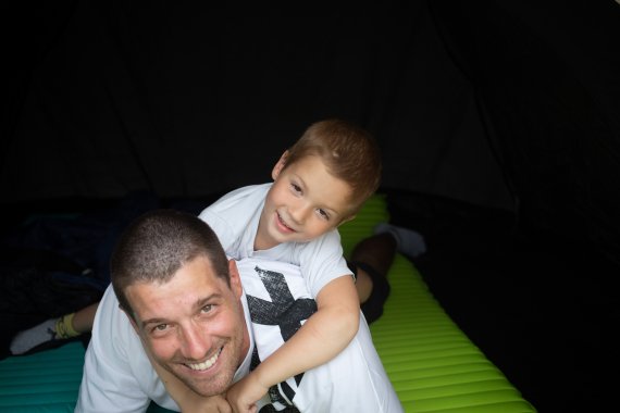 Peter Csonka with his son in the family tent