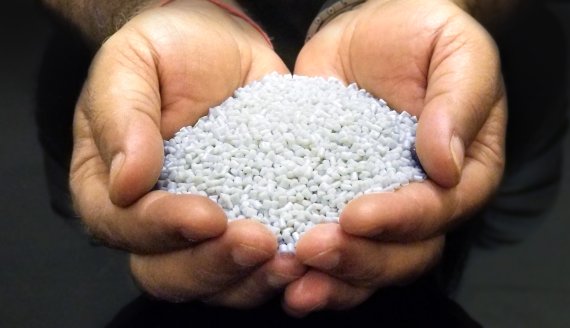 Pellets are produced from plastic collected from the oceans prior to being extruded as yarn.