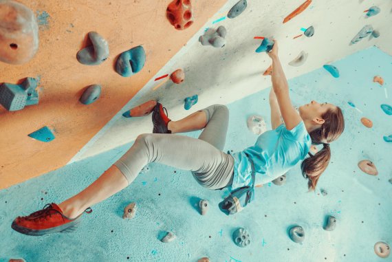 Eine Frau an der Boulder-Wand.