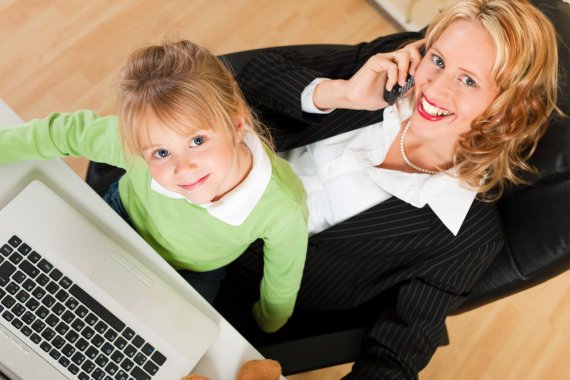 mb-151126-ThinkstockPhotos-155872497 Eine Frau telefoniert, während sir mit ihrer Tocher am Laptop sitzt.
