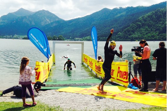 Participant of Schliersee triathlon in southern Bavaria while leaving swimming stage.