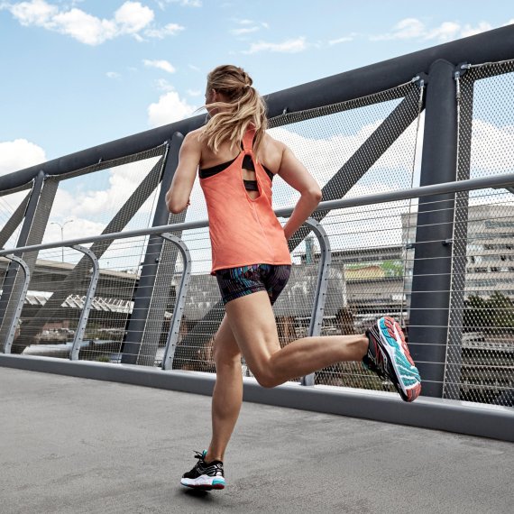 mb-saucony_ispo Frau beim Joggen auf einer Brücke.