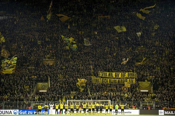 mb-bundesliga_umsatzrekord Die Mannschaft von Borussia Dortmund feiert vor der Südtribüne.