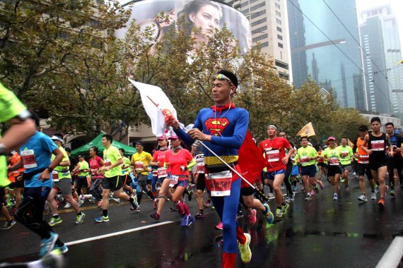 mb-160707-running-shanghai A Chinese man dressed as Superman running at the Marathon Shanghai.