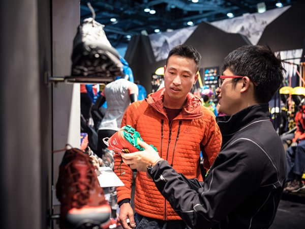 Salesperson shows customer sports shoes