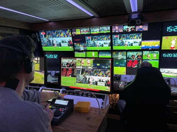 A broadcast van at a soccer match.