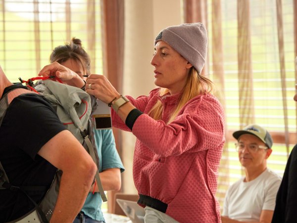 A woman examines a rucksack.