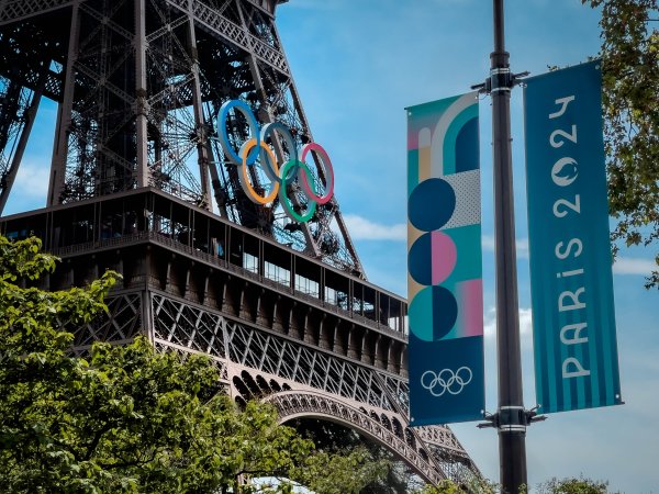 The Olympic rings hang from the Eiffel Tower
