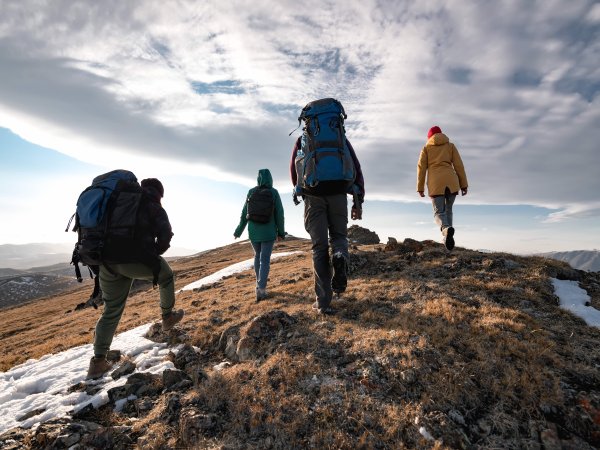 Four people hiking on a mountain