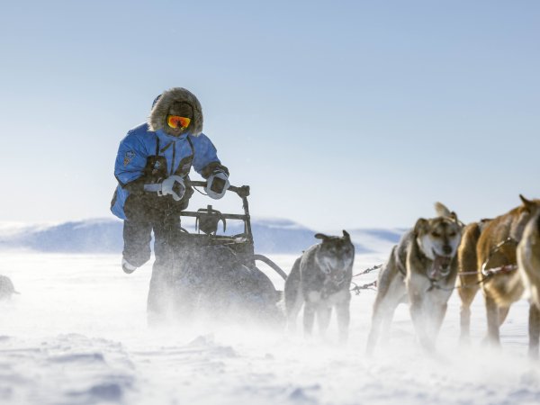 Dog sled expedition in arctic landscape by Fjällräven