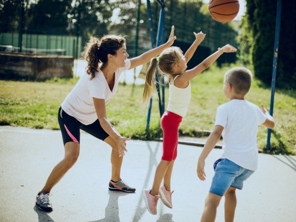 Mother plays basketball with her two children