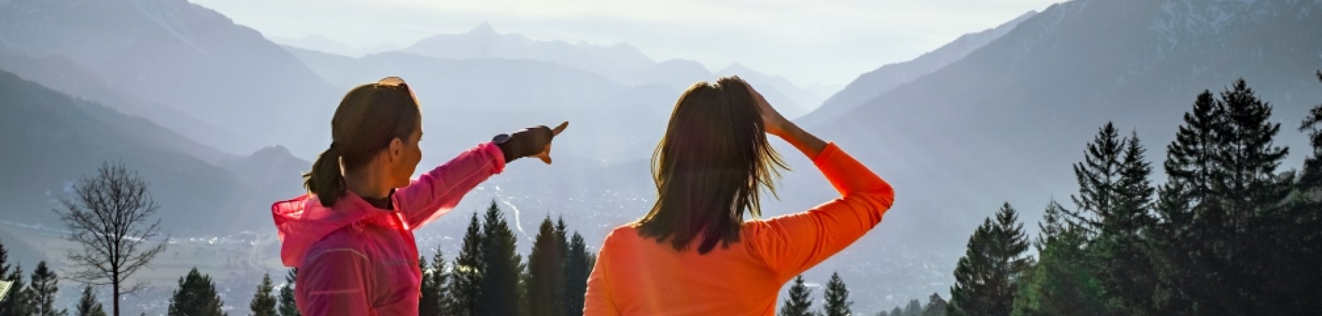 Two women looking at a mountain