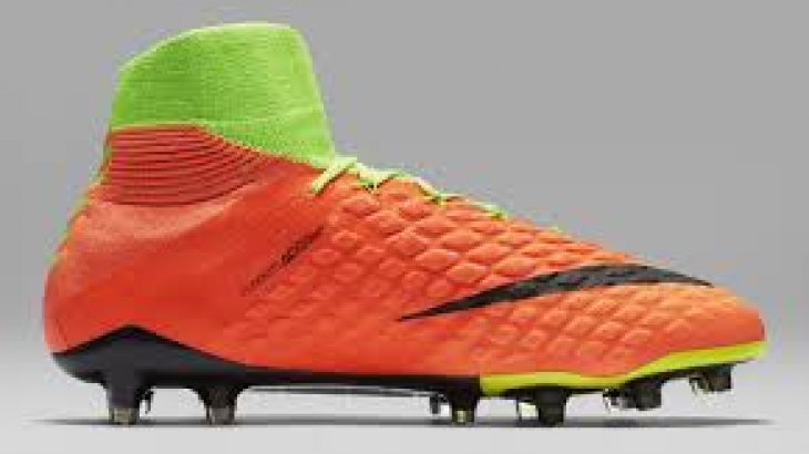 Orange football boot by Nike. 