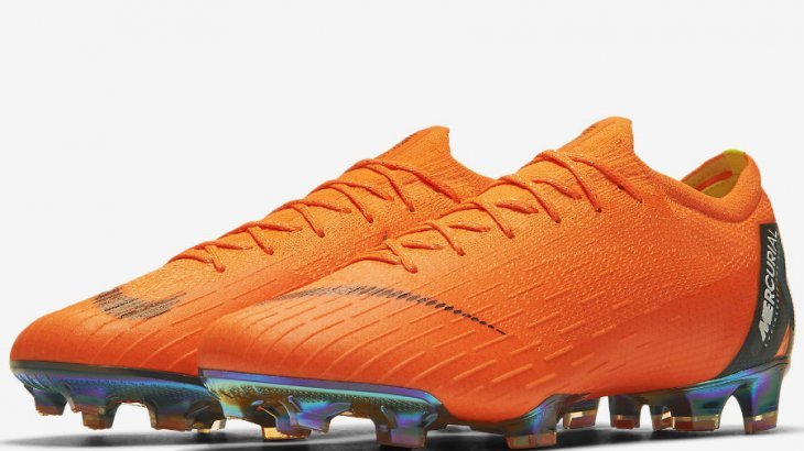Orange football boot by Nike.
