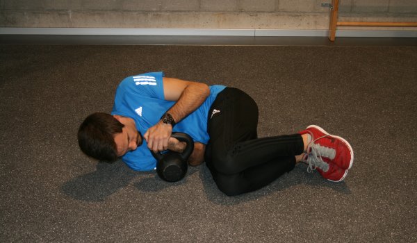 On the side lying with the kettlebell over the lower wrist "cuddling".