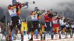 Biathletes stand in line and shoot.