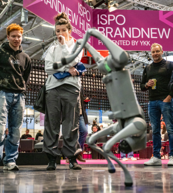 Personen stehen um einen Roboter im ISPO Brandnew Hub