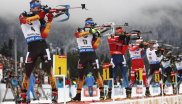Biathletes stand in line and shoot.