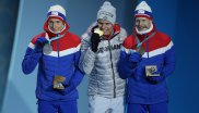 Yeah, the medal's real. Andreas Wellinger, Olympic champion in ski jumping from the normal hill, with the obligatory bite in his gold medal. With him on the podium the two Norwegians Johann André Forfang and Robert Johansson