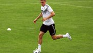 Defender Matthias Ginter naturally looks at the ball on a football field.
