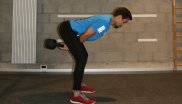 When the ball swings back between the legs, the hip bends quickly and intercepts the swing of the ball. Accelerate the kettlebell again or swing it to the end.