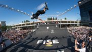 The guys with the scooters are showing spectacular stunts in the halfpipe.