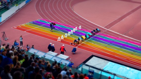 Tartan track in station colored in rainbow colors.