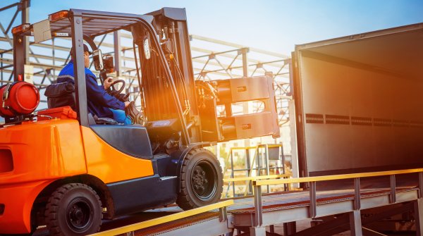 Man in forklift transporting goods