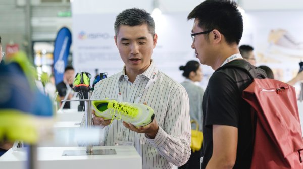 Visitors having a look at yellow sports shoes