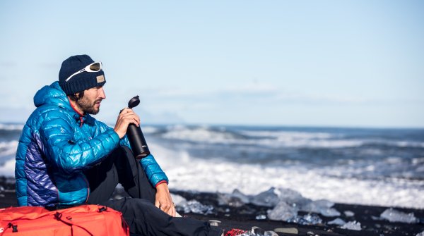 Man with his Thermos bottle drinking 