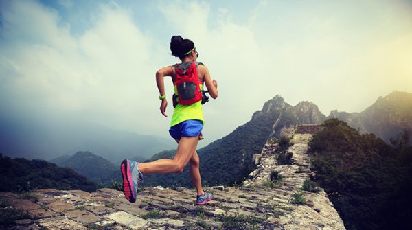 Asian women runs a on Chinese wall