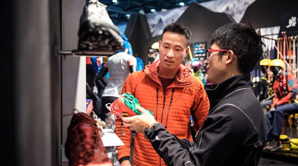 Salesperson shows customer sports shoes