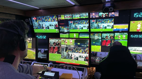 A broadcast van at a soccer match.