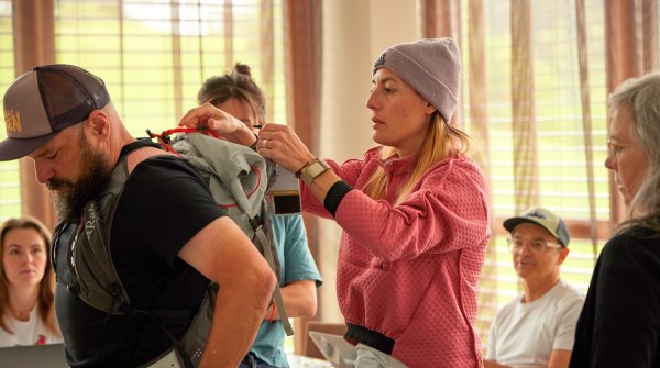 A woman examines a rucksack.