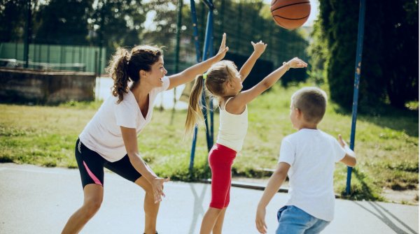 Mother plays basketball with her two children