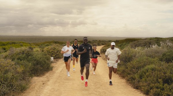 A group of runners jog through the countryside.