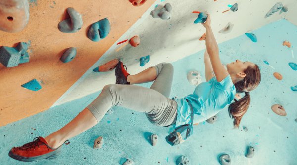 Eine Frau an der Boulder-Wand.